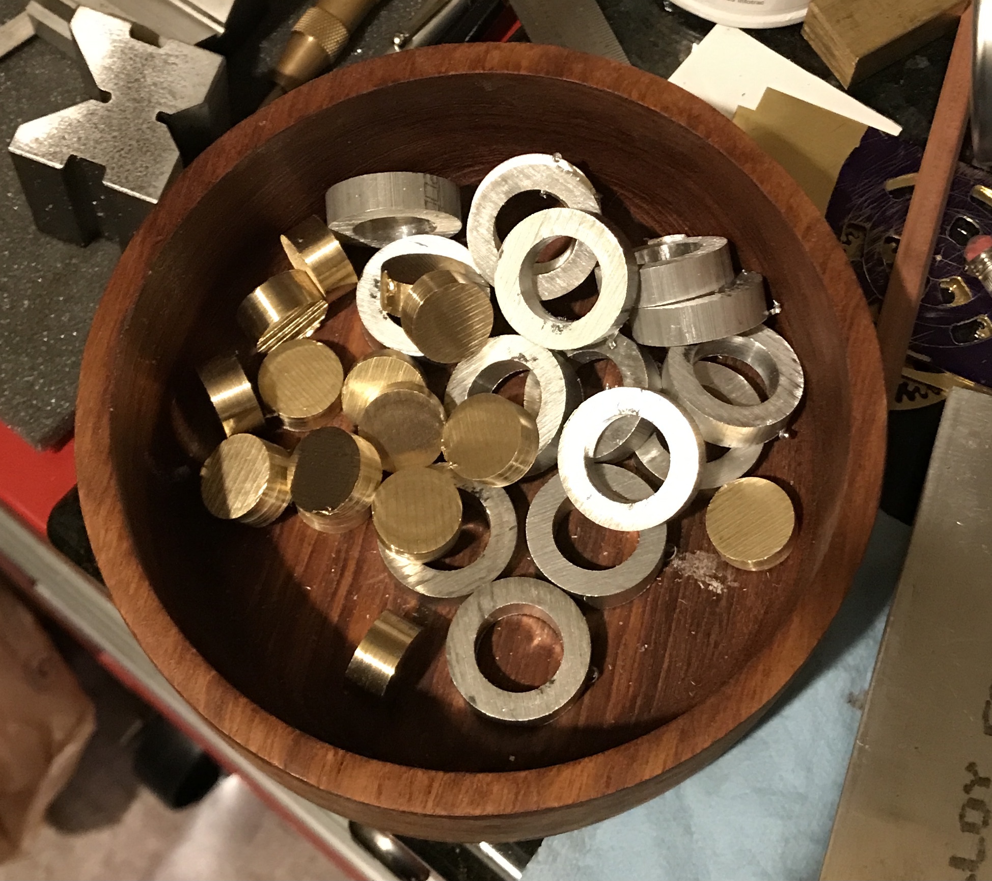 Fifteen brass disks and fifteen aluminum rings.